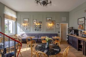 a living room with a table and chairs and a couch at Hotel Bregenz in Berlin