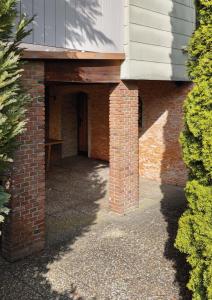 a brick hallway of a building with a table on it at Residence KESH in Krumbach