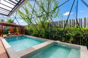 a swimming pool in the middle of a building at Sawasdee pool villa, Hua Hin in Hua Hin