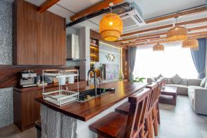 a kitchen with a counter and a living room at Sawasdee pool villa, Hua Hin in Hua Hin