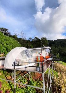 a dome house on a boat in a field at ออโต้แคมป์ in Ban Huai Khu