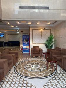 a lobby with chairs and a table and a rug at فندق سما المشاعر اجياد Sama Al Masher Ajyad in Ajyad