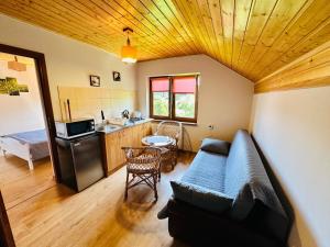 a living room with a couch and a kitchen at Wygodne Spanie in Cisna +11 photos
