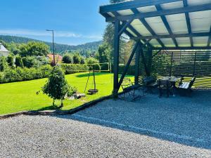 a gazebo with a swing in a yard at Wygodne Spanie in Cisna