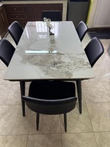 a dining table with a marble top and chairs at Emam apartments in Grand-Baie
