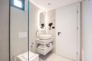 a bathroom with a toilet sink and a mirror at Maesa Suite in Borsh +32 photos