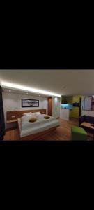 a bedroom with a large bed and a couch at FeWo Hirsch in Todtmoos