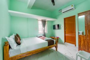 a bedroom with a bed with blue walls at B2N Hotels Near Sri Ramachandra Hospital Porur in Chennai +17 photos