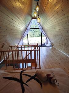 a bed in a room with a large window at Ren a frame qusar in Qusar