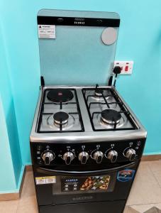 a stove top oven sitting in a kitchen at Nexus Staycations in Maralal +3 photos