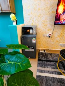 a room with a trash can and a tv at Nexus Staycations in Maralal