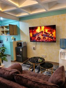 a living room with a couch and a fireplace at Nexus Staycations in Maralal