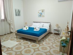 a bedroom with a bed with a blue mattress at Casa Monteserrato in Terrasini