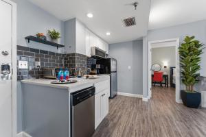 a kitchen with white cabinets and a stove at Volcano View 2 Bed 2 Bath Condo with Balcony in Orlando