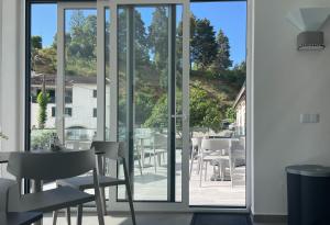 a restaurant with a view of a patio with tables and chairs at Casa de Campo Vale do Ceira in Góis
