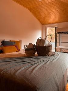 a bedroom with a bed with a tub on it at Casa de Campo Vale do Ceira in Góis