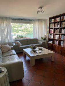 a living room with a couch and a coffee table at Casa Giardinetto in Brusino Arsizio