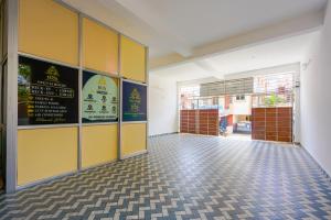 an empty room with yellow doors and a tile floor at B2N Hotels Near Sri Ramachandra Hospital Porur in Chennai
