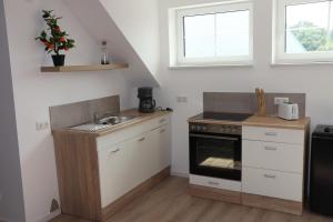 a kitchen with a sink and a stove at Ferienoase übern Zottbachtal in Pleystein