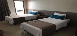 Postel nebo postele na pokoji v ubytování Racini Suites Hotel + 7 fotografií