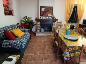 a living room with a table and a fireplace at B&B - Casale di Mary in Contigliano