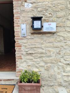 a stone wall with two signs on a building at B&B - Casale di Mary in Contigliano