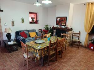a living room with a table and a couch at B&B - Casale di Mary in Contigliano +4 photos