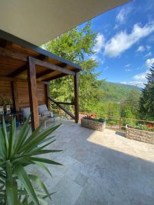 an outdoor patio with a view of the mountains at Stone Apartment with sauna Sinaia in Sinaia