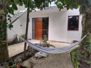 a hammock in front of a house at BACHÍG Hospedaje in Moyobamba