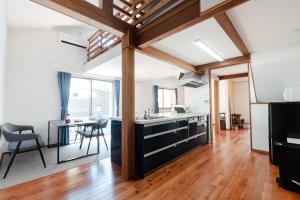 a kitchen with a counter and a dining room with a table at 1日1組限定 一棟貸し Japanese Traditional House Three Field Tamba-Sasayama in Sasayama