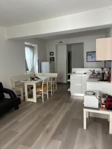 a kitchen and living room with a table and a kitchen and a dining room at Appartamento Michela in Darzo +24 photos