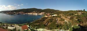 an aerial view of a village on a hill next to the water at Nicolas Rooms in Fiskardo