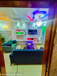 a living room with a couch and a game console at Skyline Guest House in Kinshasa