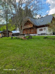 a large house with a large yard in front of it at Waldheimathütten in Sankt Kathrein am Hauenstein