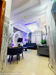 a living room with a couch and a table at Skyline Guest House in Kinshasa