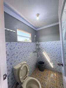 a bathroom with a toilet and a shower at Georium Dunia in Prambanan +53 photos