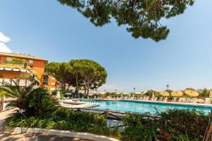 a pool at a resort with chairs and umbrellas at "The Lavender Spot" con accesso alla spiaggia in Arenzano