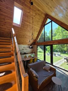 a room with stairs and a couch in a cabin at Cabana ONYX Baile Olanesti in Băile Olăneşti