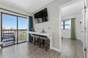 a living room with a table and a balcony at Lake View Top Floor 2 Bed 2 Bath Condo with Balcony in Orlando