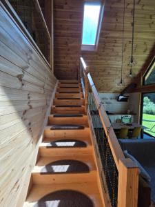 a staircase in a house with wooden walls and ceilings at Cabana ONYX Baile Olanesti in Băile Olăneşti