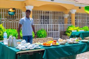 a man standing in front of a table with food at Lake Front Apartment in Georgetown +28 photos