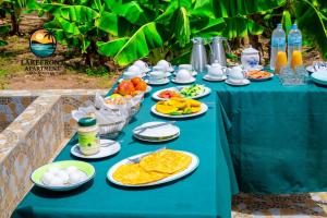 a blue table with plates of food on it at Lake Front Apartment in Georgetown