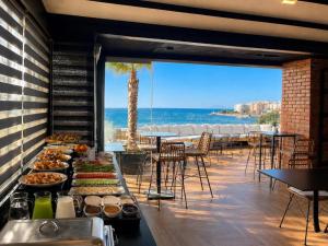 a buffet line with a view of the beach at Diamond Prestige Hotel in Sarandë