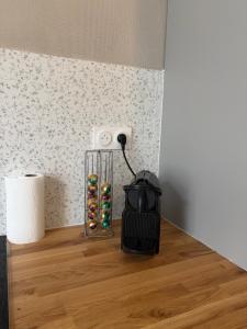a glass vase with some donuts on a table at Appartement centre-ville Montluel in Montluel
