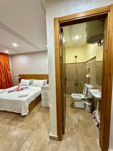 a bedroom with a bed and a toilet and a sink at hotel el amri akchour in Akchour +112 photos