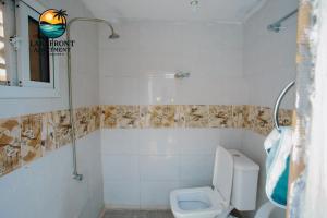 a bathroom with a toilet and a sink at Lake Front Apartment in Georgetown
