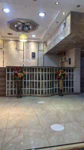 a room with two vases with flowers in it at فندق نوارة المنسك in Abha