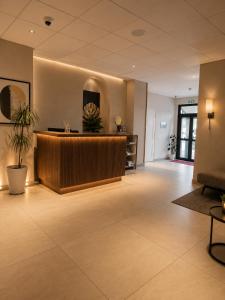 a lobby with a reception desk in a building at Hôtel L'Alsace Gare-Sncf in Narbonne