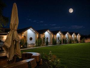 a row of lodges at night with a full moon at บ้านต้นจันทร์ in Nathon Bay +14 photos