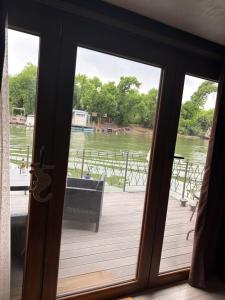 a door to a deck with a view of the water at Vasilisa Luxury River House in Pančevo +1 photo